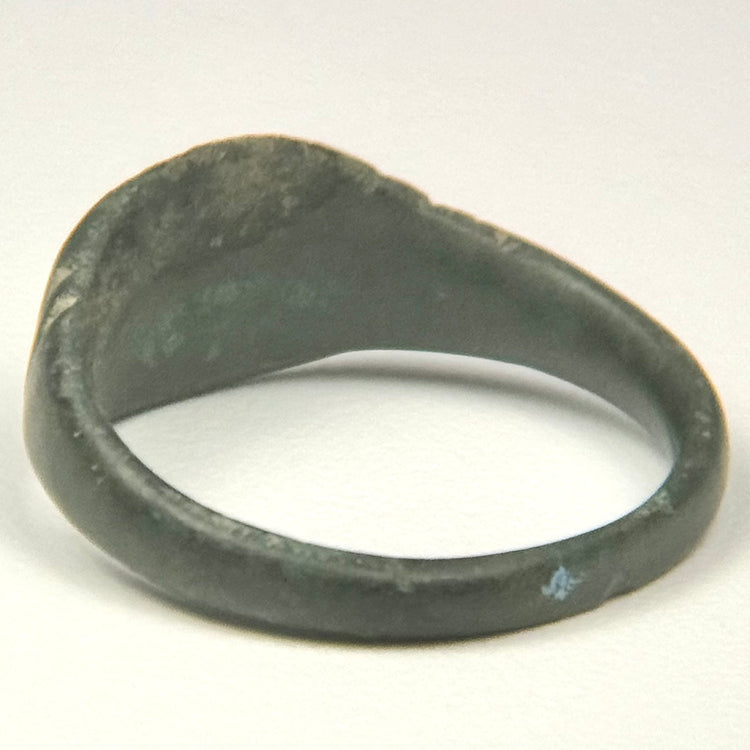 Ancient Roman copper-alloy finger ring with broad oval face and double transverse shoulder grooves
