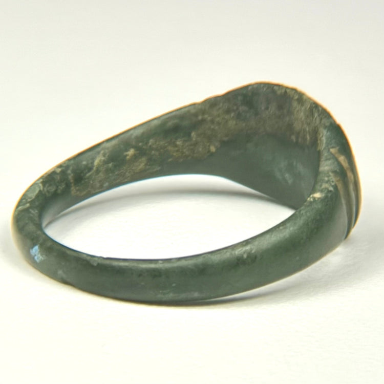 Profile view of ancient Roman bronze ring showing solid cast construction and thick expanding shoulders
