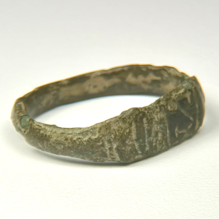 Late Roman bronze ring with letter-like engraved marks and geometric shoulder decoration