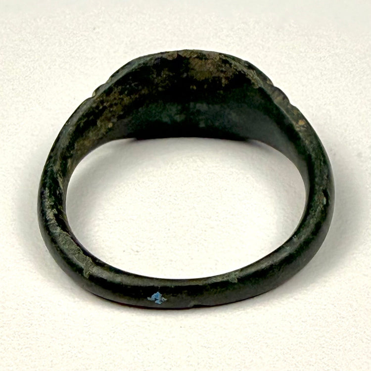 Eastern Mediterranean Roman bronze finger ring with broad integral bezel and simple geometric shoulder decoration