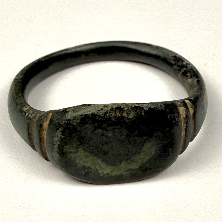 Ancient Roman bronze broad-bezel ring, circa 2nd–3rd century CE, with paired grooves and dark aged patina