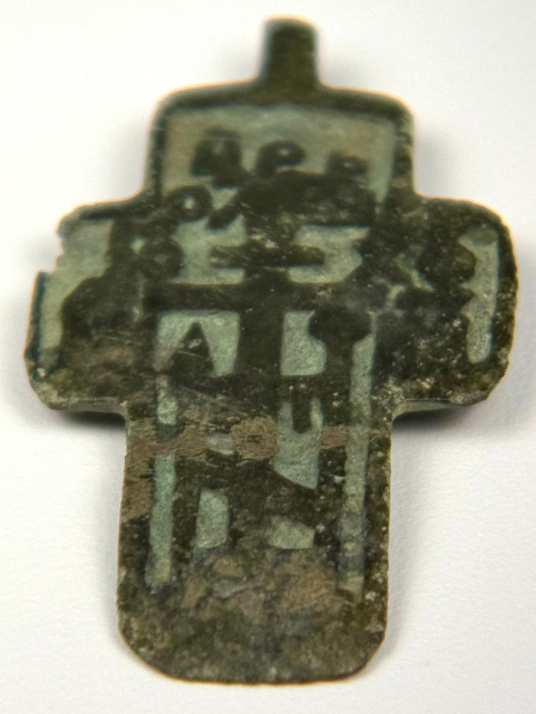 Russian Old Believer Orthodox cross-plaquette in cast copper-alloy with green champlevé enamel remains and Cyrillic inscriptions, c. 1780–1820.