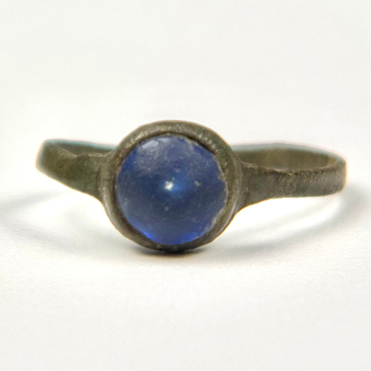 Front view of Roman bronze ring with domed cobalt blue glass stone in circular bezel
