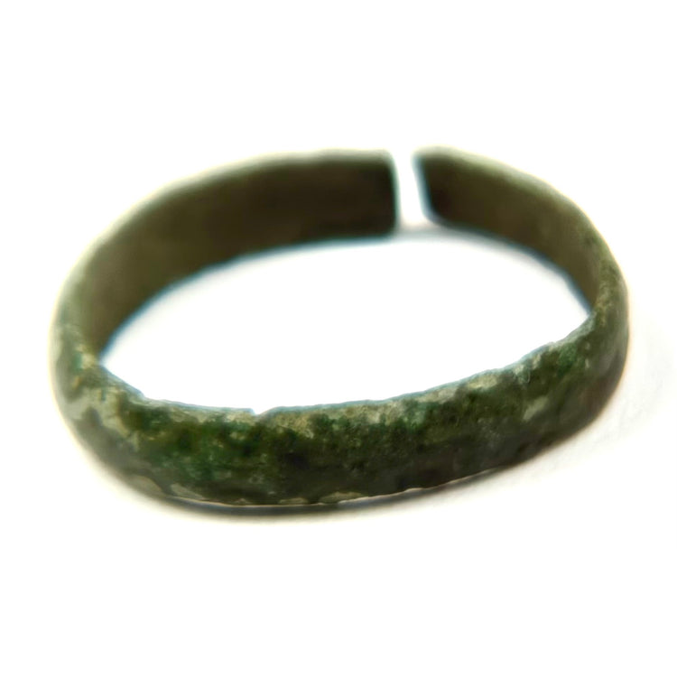 Ancient open bronze finger band with green patina and visible age-related surface encrustation, Late Roman to Byzantine period