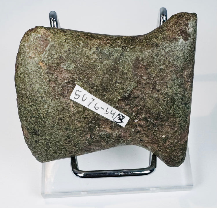Side view of a Pre-Columbian Ecuadorian or Peruvian stone axe with distinctive hafting notch and thick ground-stone profile.