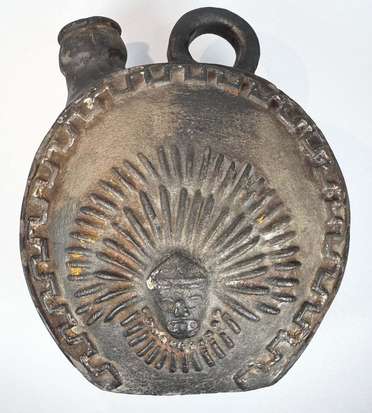 Peruvian ceramic canteen with bold relief decoration and rounded body