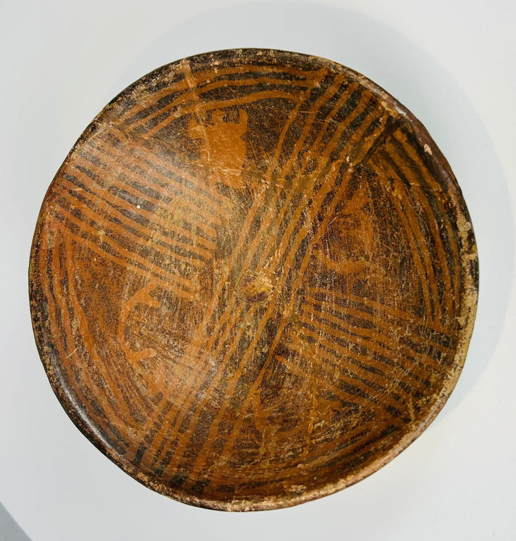 Pre-Columbian painted ceramic bowl with geometric designs and worn surface decoration