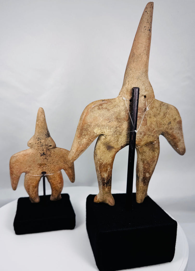 Three-quarter view of Pre-Columbian Colima terracotta figures with mineral deposits and burial patina