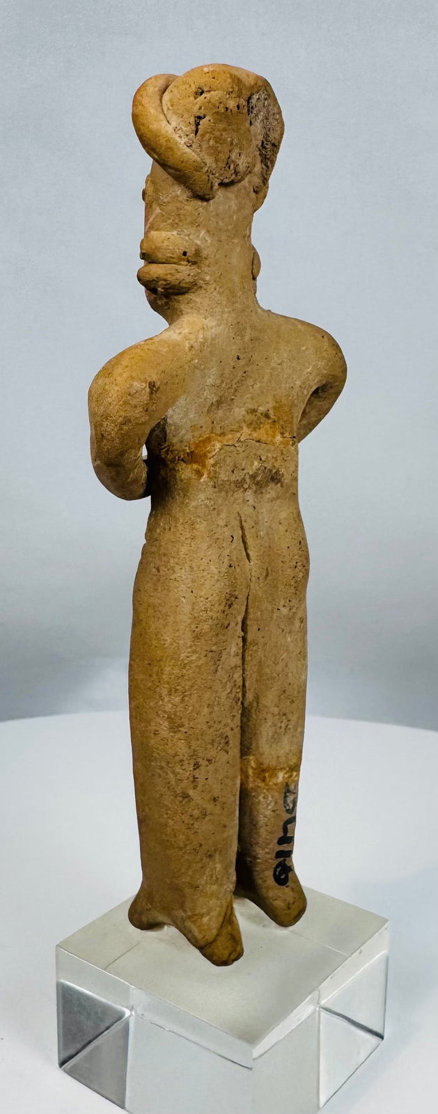 West Mexico terracotta fertility figure with warm earthen patina and expressive stylized features.