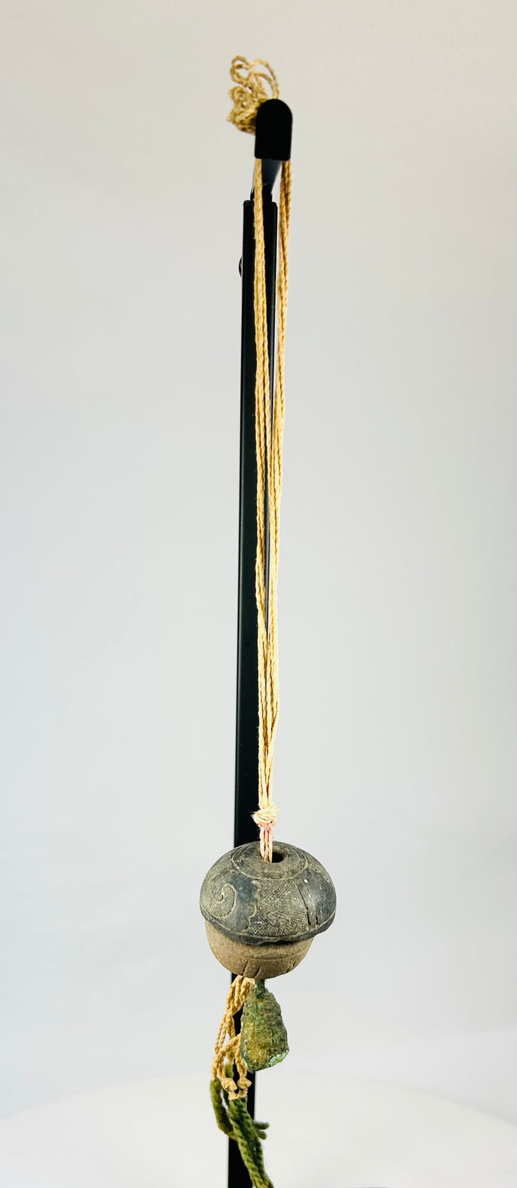 Detailed upper section showing twisted cord attachment and aged fiber condition