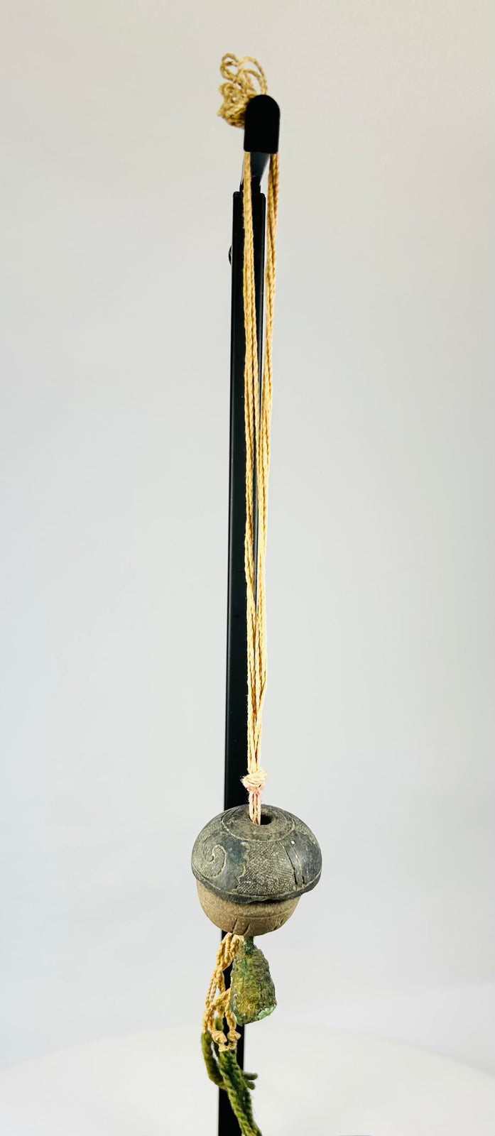 Detailed upper section showing twisted cord attachment and aged fiber condition