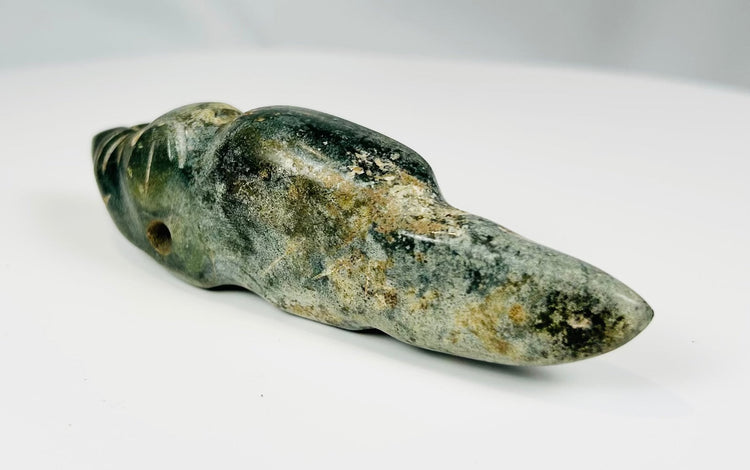 Ancient carved greenstone effigy pendant with elongated tail and drilled eye details