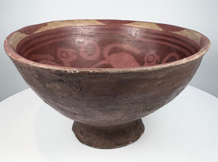 Pre-Columbian Colombian ceramic bowl with bichrome slip, concentric interior patterns, and stylized animal imagery.