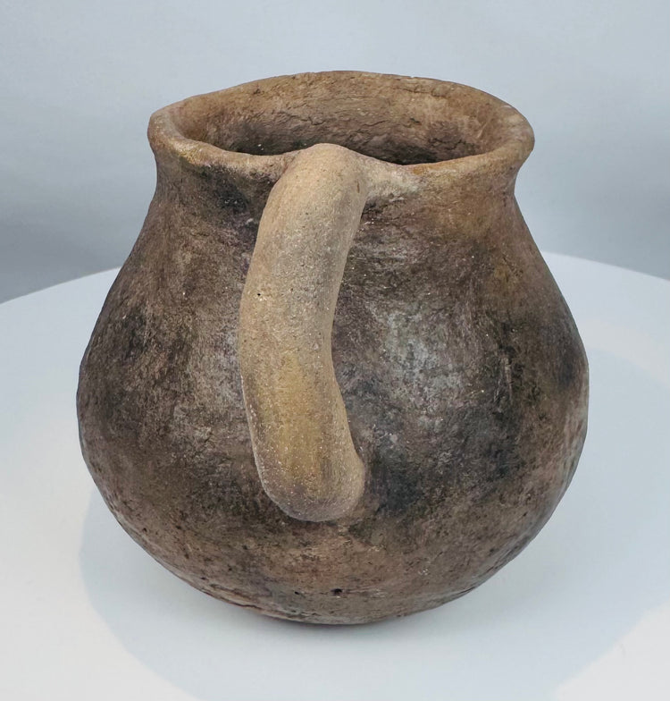 Ancient northern Mexican pottery mug from the Paquimé culture featuring a smooth earthenware surface and functional utilitarian design.