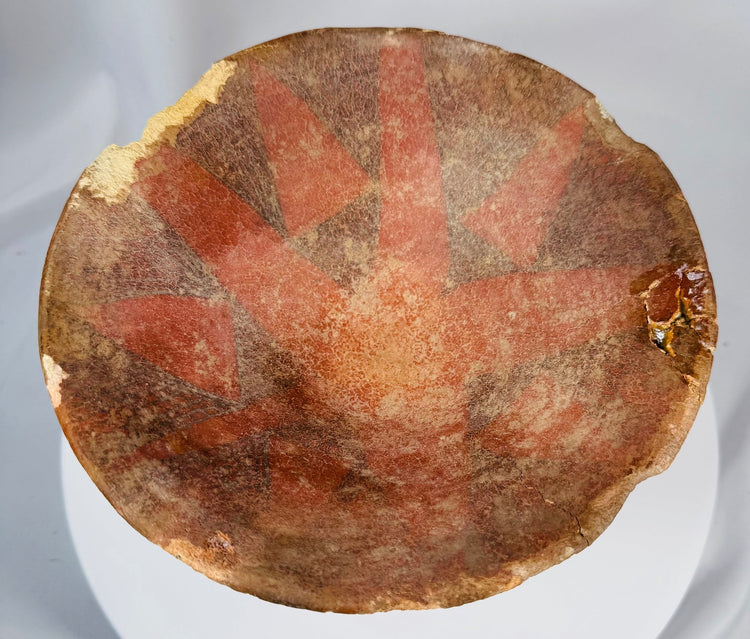 Ancient Central or South American pedestal vessel with restored cracks, painted ornamentation, and earthenware construction.