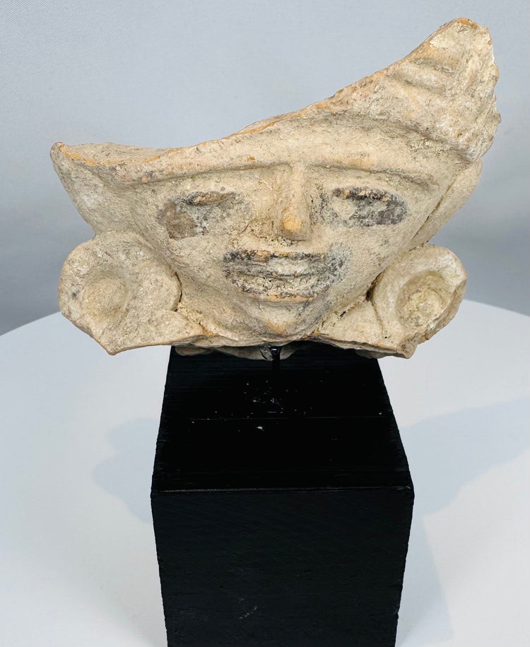 Ancient Veracruz-style terracotta figure fragment mounted on a custom display stand.