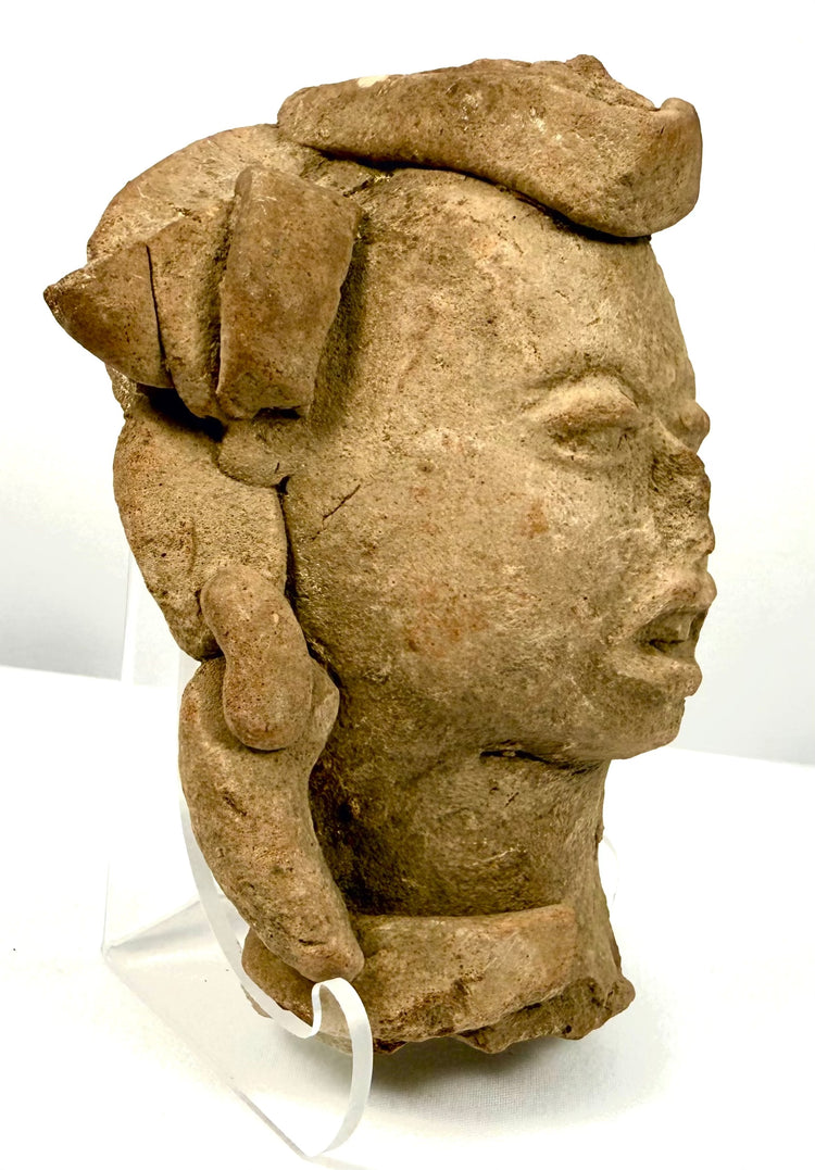 Three-quarter angle of ceremonial terracotta head with ornate crown-like headdress