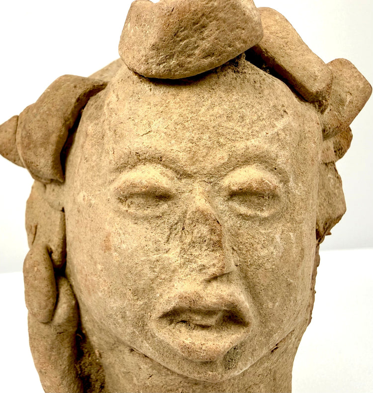 Pre-Columbian terracotta head artifact with elaborate headdress and expressive facial features