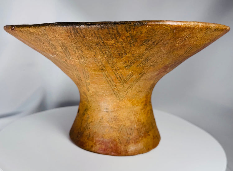 Ancient ceremonial earthenware bowl with geometric decoration and natural mineral deposits