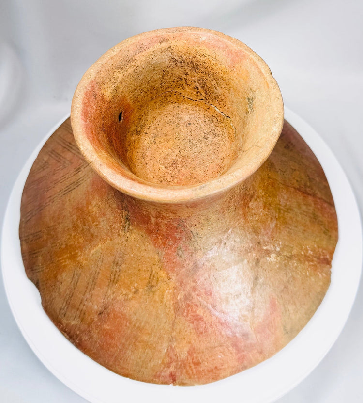 Ancient terracotta ceremonial bowl from Mesoamerica with elevated pedestal foot