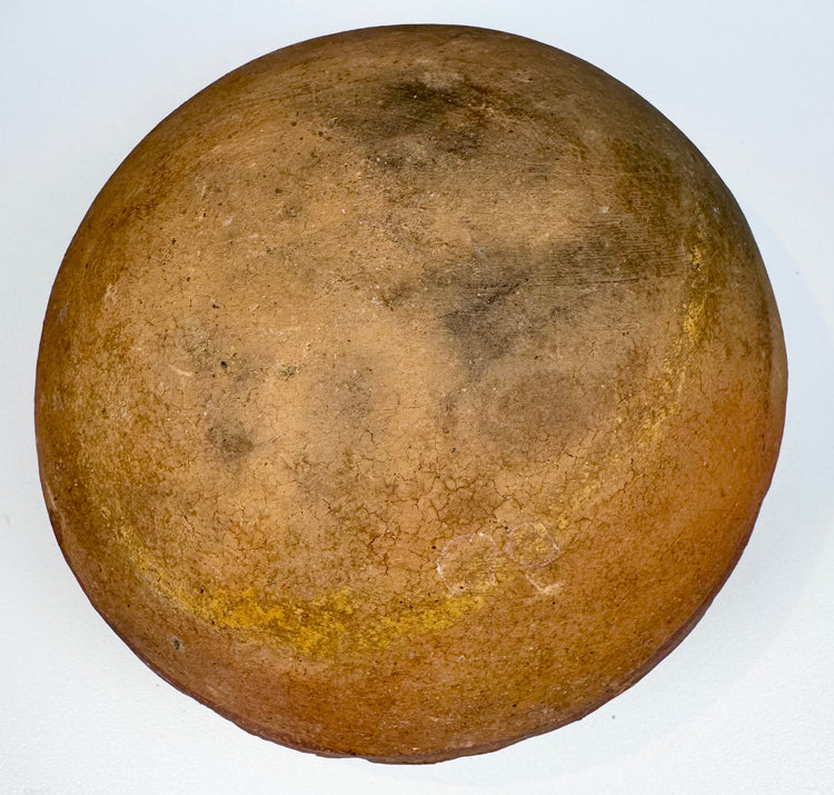 Ancient sculpted clay vessel from the Pre-Columbian Americas with raised ornament and preserved earthen surface.