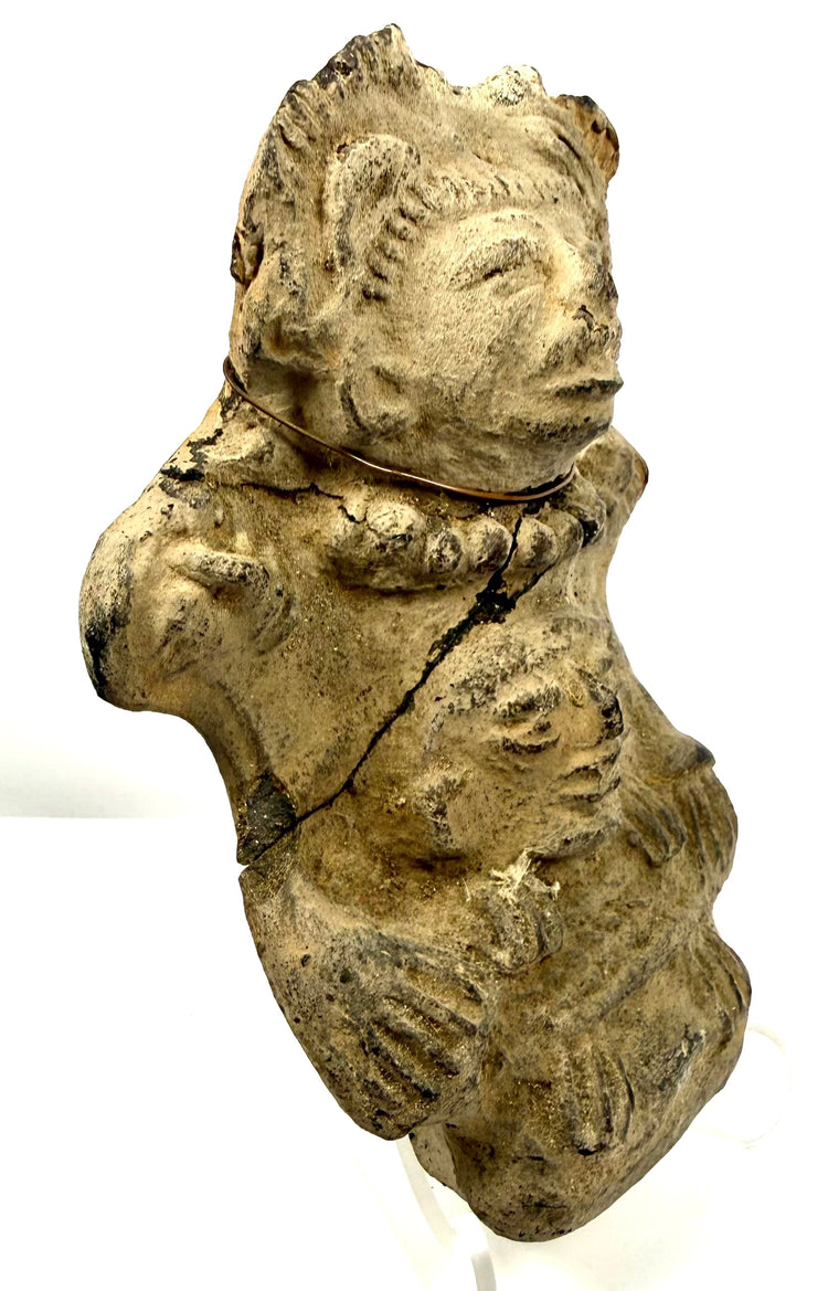 Angled view of stacked figure ceramic emphasizing depth of upper headdress design