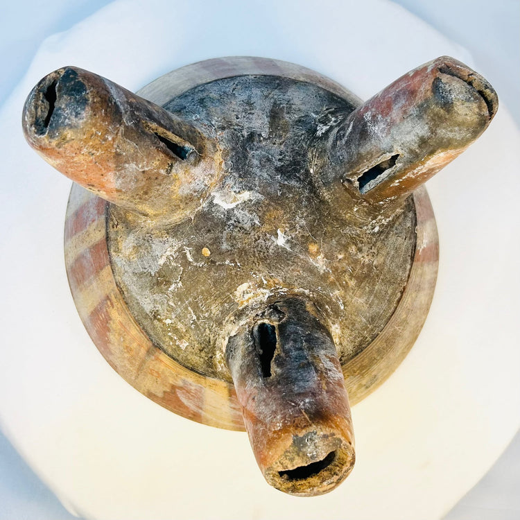 Underside view of ancient West Mexican tripod bowl showing hollow legs