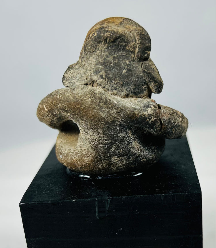 Pre-Columbian Mesoamerican terracotta effigy sculpture showing encrustation, age wear, and strong expression