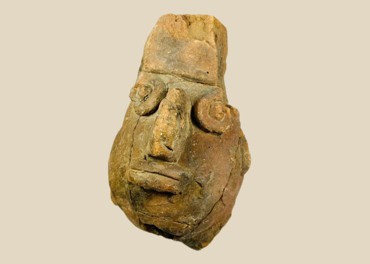 Pre-Columbian anthropomorphic spouted jar from the Valdivia–Chorrera culture, Ecuador, shaped as a stylized human head with large circular eyes, broad nose, and pronounced lips; hand-molded terracotta with earthy patina, ritual vessel dating to early Andean traditions, showing surface wear and archaeological age cracks.