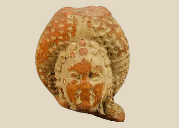 Pre-Columbian terracotta head fragment, circa 500–1200 CE, with serene facial features, ornate headdress, and traces of red and white pigment.