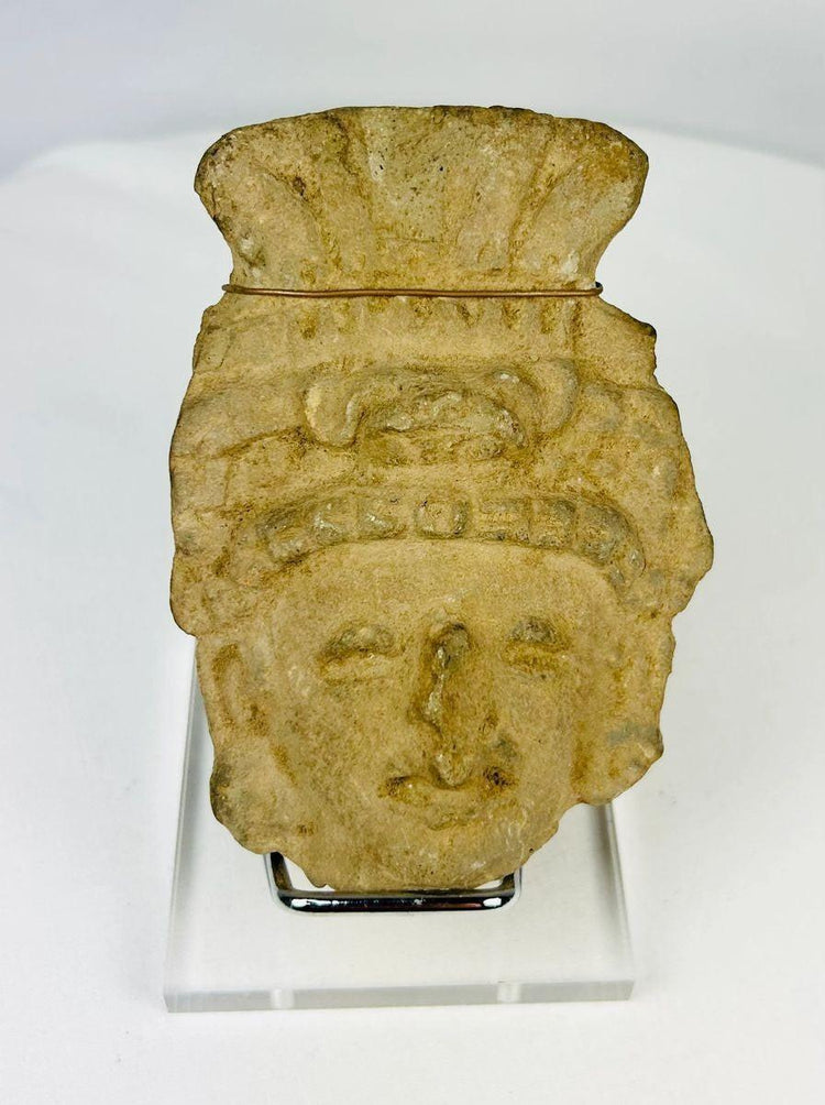 Pre-Columbian terracotta head fragment, circa 1st millennium CE, with stylized facial features and ornate fan-like headdress, weathered patina.