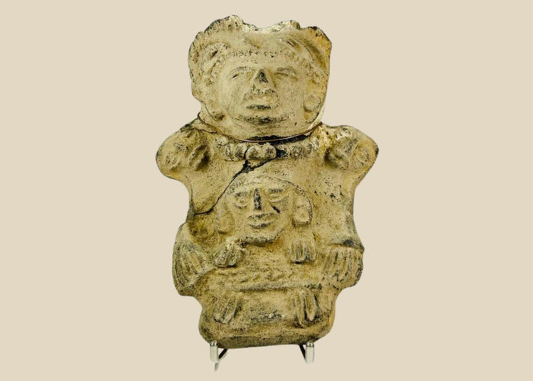 Ancient Pre-Columbian Veracruz ceramic effigy depicting two joined human figures, hand-modeled with stylized facial features and incised details, tan clay with surface wear and encrustation, dating to circa 300 BCE–600 CE, representing Mesoamerican ritual and symbolic artistry.