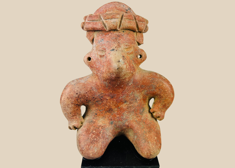 Pre-Columbian West Mexico terracotta figure with headdress on museum stand