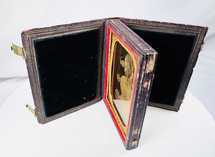 Victorian cased ambrotype with women wearing gingham dresses and an elaborate bonnet