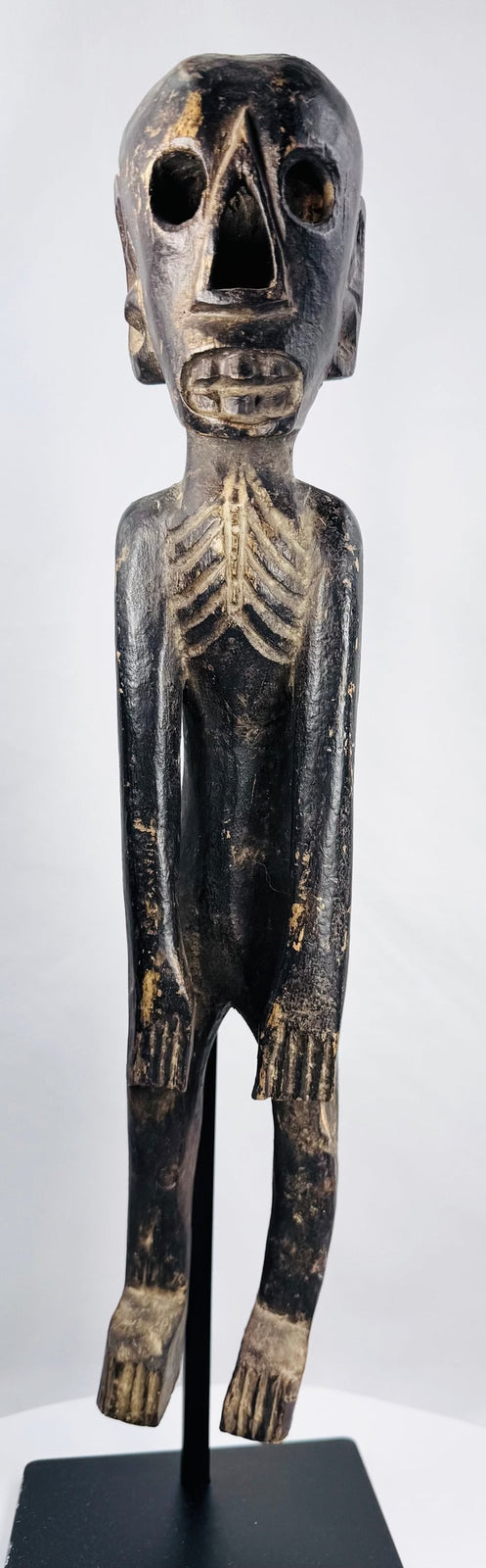 Early 20th-century Rapa Nui-inspired wooden figure with elongated skeletal form