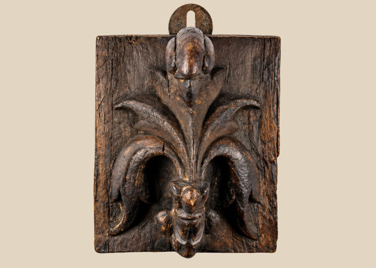 Small 16th-century European carved wooden devotional panel depicting the Pelican in Her Piety with zoomorphic scrollwork and traces of polychrome paint, Renaissance period.