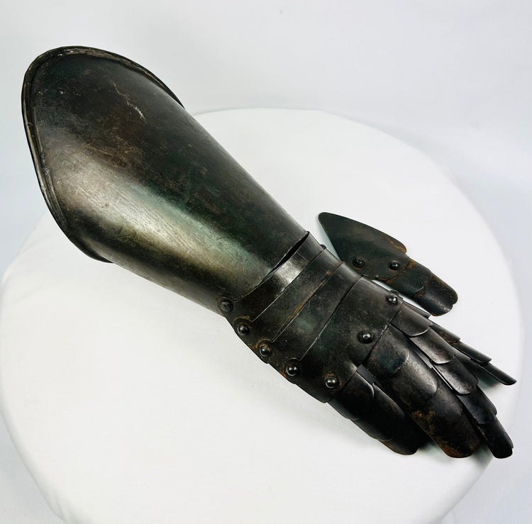 Right-hand articulated steel gauntlet photographed on white background with visible wrist lames and finger plates.