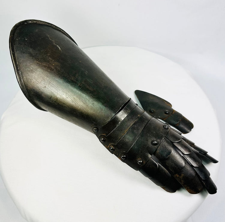Right-hand articulated steel gauntlet photographed on white background with visible wrist lames and finger plates.