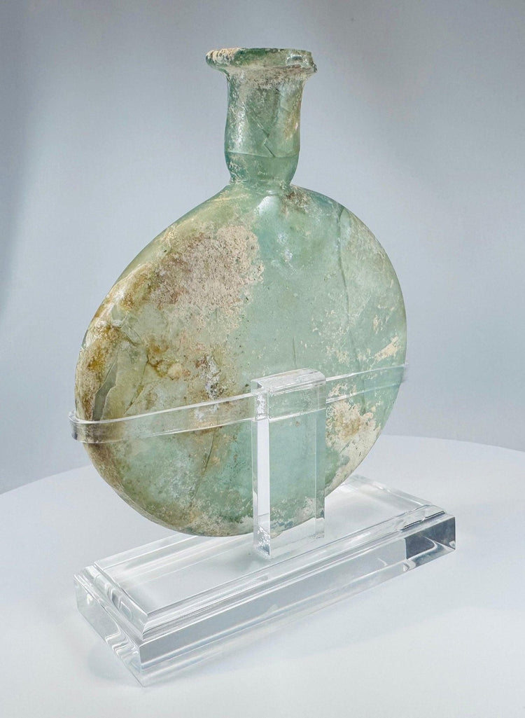 Free-blown Roman glass perfume vessel with flattened body and long cylindrical neck