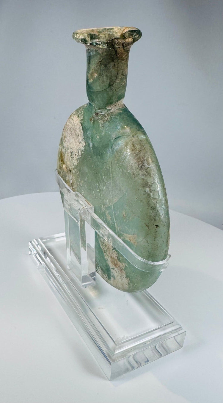 Early Roman free-blown glass cosmetic flask with archaeological weathering and repaired neck