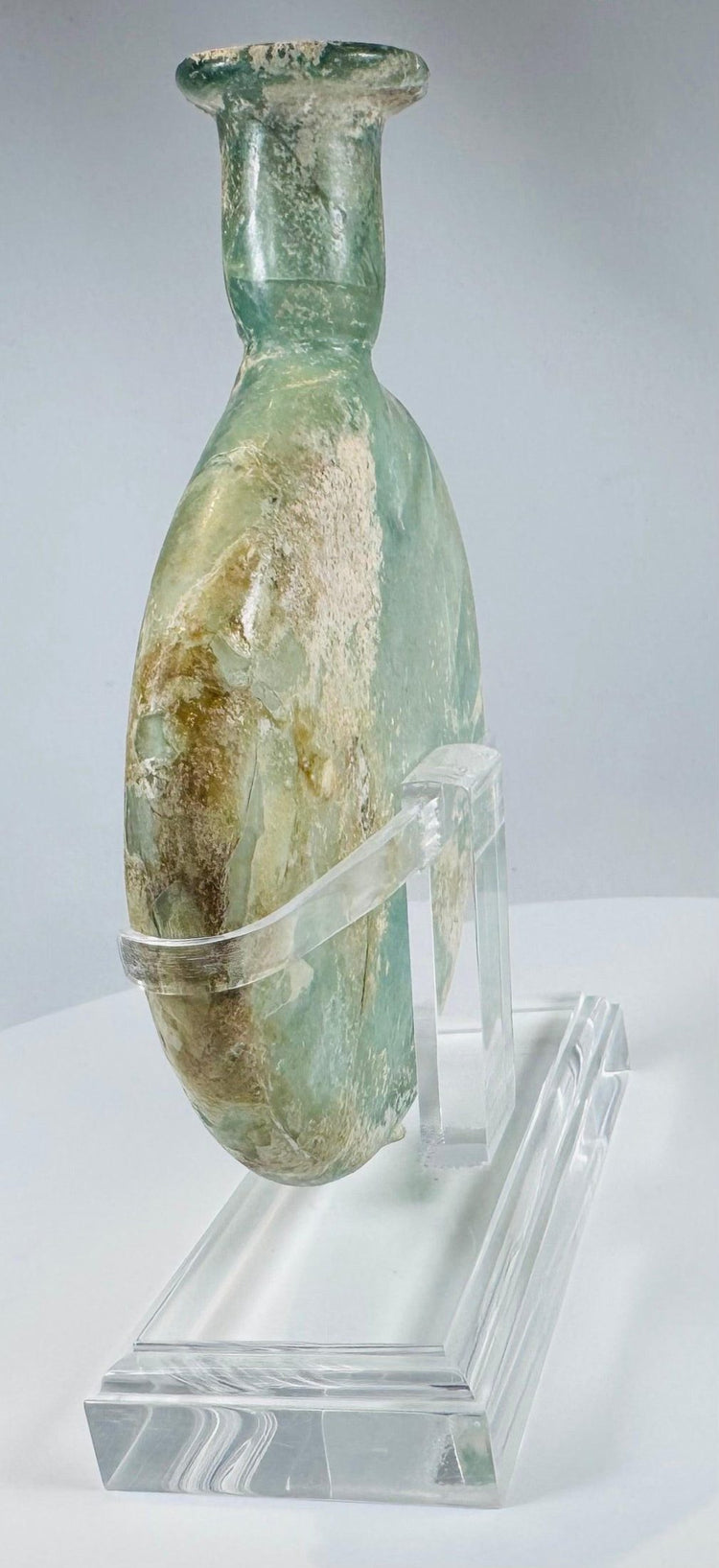 Ancient Roman glass flask used for oils or perfumes with visible pontil evidence