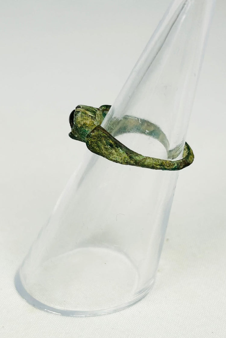 Archaeological Roman jewelry artifact displayed on museum-style black presentation stand