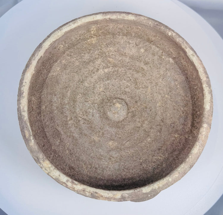 Broad Roman pottery bowl from ancient Tunisia showing weathered earthenware surface and centuries of natural mineralization.
