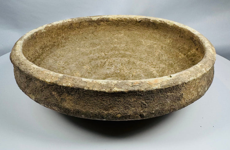 Side profile of a Roman North African pottery bowl illustrating its thickened rim and gently sloping walls.