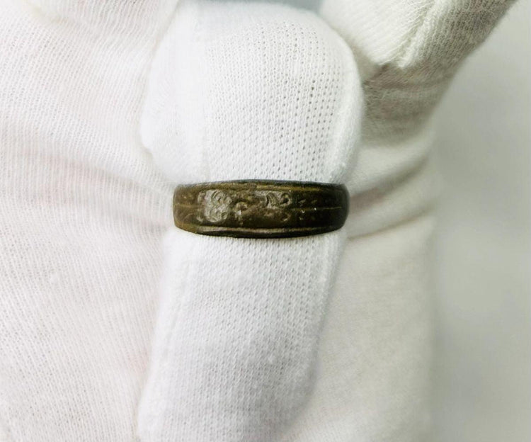Ancient Roman bronze band ring, 1st–4th Century CE, featuring incised decorative motifs around the circumference. Worn as personal adornment and possibly symbolic of status or identity, with natural patina from centuries of age and use.