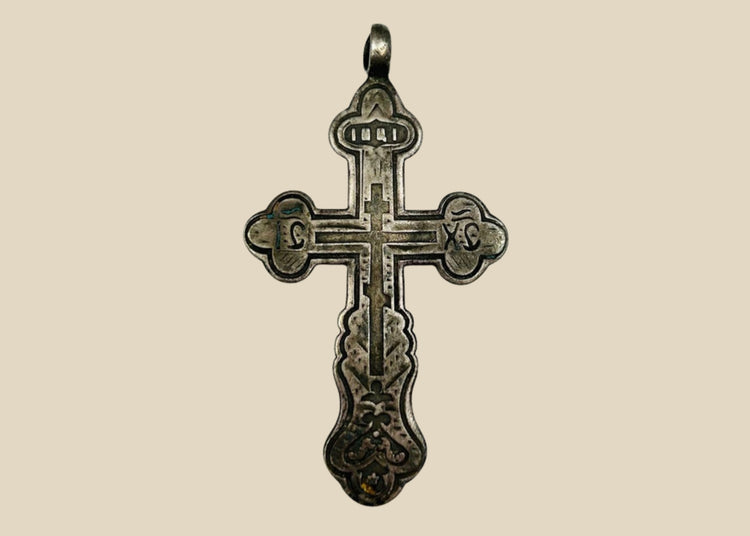 Antique Russian Orthodox silver cross pendant, 18th Century CE. Classic cruciform shape with additional upper crossbar and engraved Cyrillic inscriptions, including “IC XC” for Jesus Christ. Compact wearable devotional pendant with natural silver patina, reflecting Eastern Orthodox artistry, faith, and spiritual symbolism.