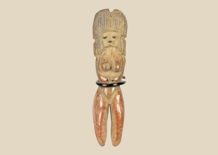Molded terracotta figurine of seated female from Classic Veracruz culture, with vertical ridged headdress, bent legs, hands raised to face, incised facial features, and traces of red slip; mounted on black display stand; circa 600–900 CE, Gulf Coast of Mexico.