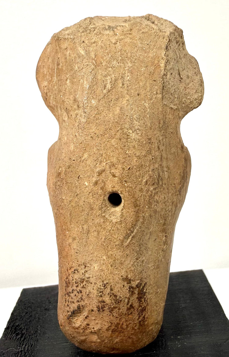 Back view of antique Veracruz terracotta figurine showing circular vent hole