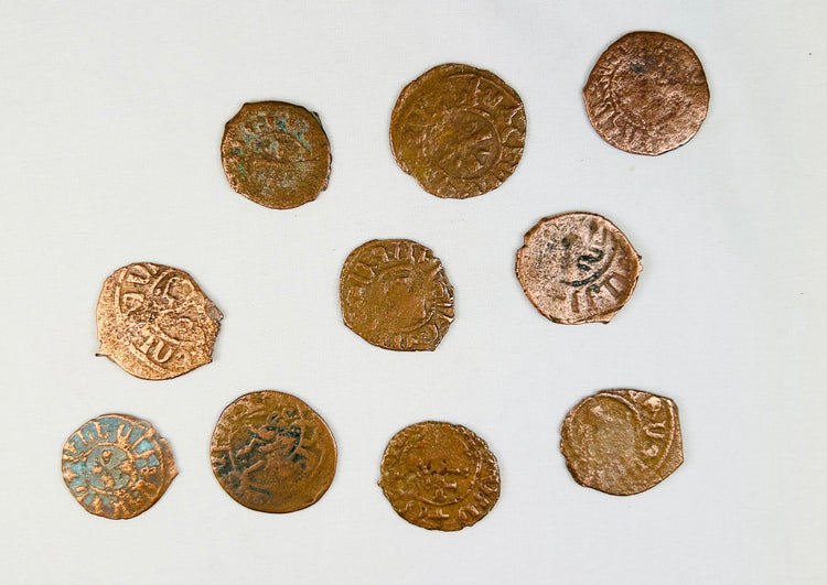 Medieval Crusader bronze coins from the Levant displaying crosses, religious motifs, and centuries-old archaeological patination.