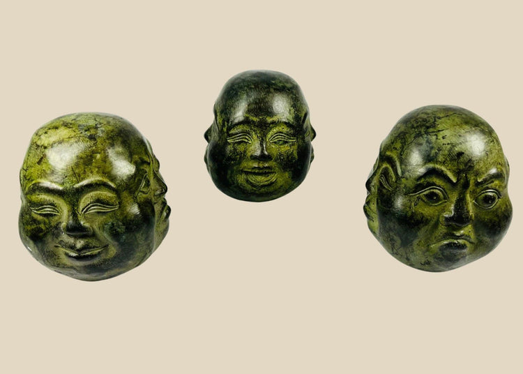 20th century Himalayan cast metal Buddha heads, sand-filled, patinated bronze finish, set of three in traditional brocade box, devotional and ritual meditation objects